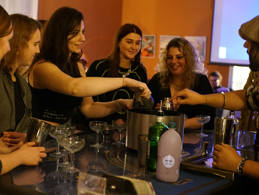 A group of women at the bar learning how to make cocktails in Bath