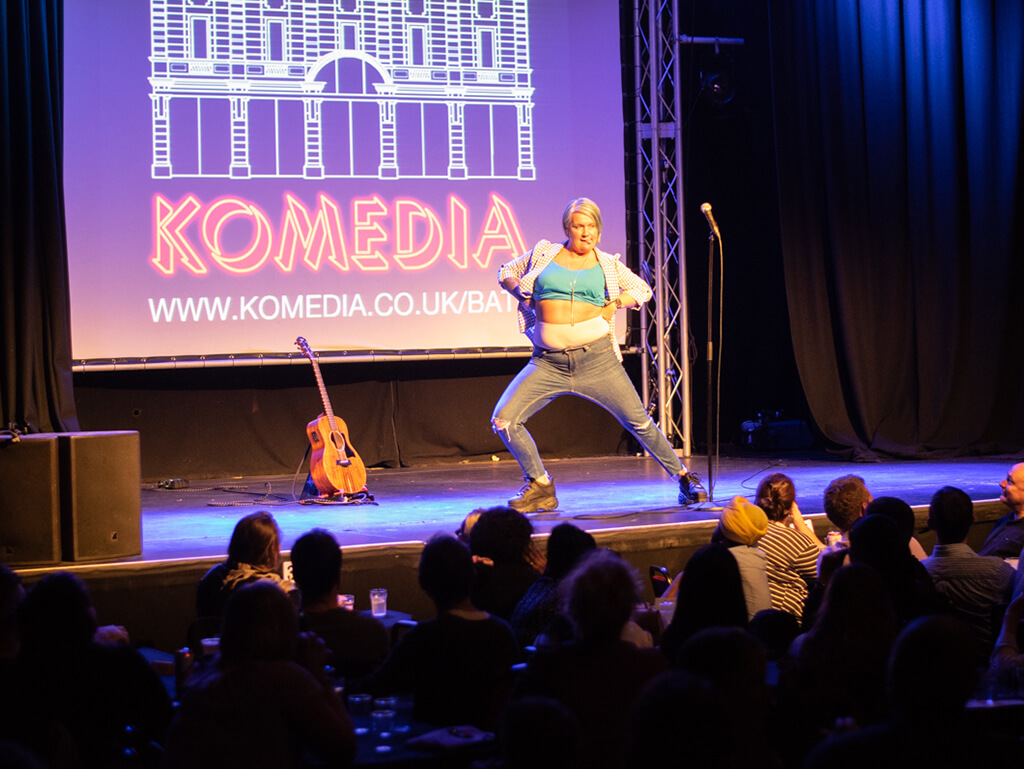 A comedian strutting their stuff on stage at Komedia in Bath