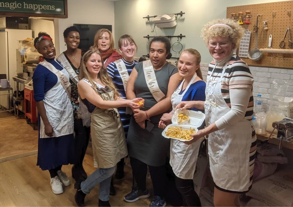 A group of hens showing the pasta they made as part of their activity