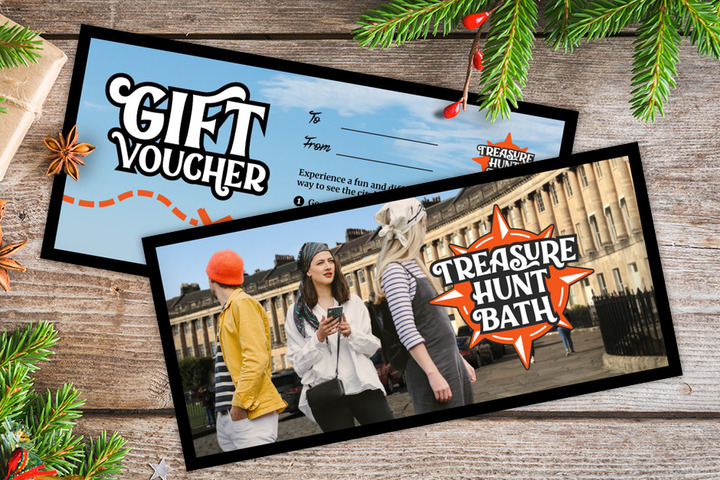 A gift voucher for Treasure Hunt Bath on a table covered with Christmas decorations