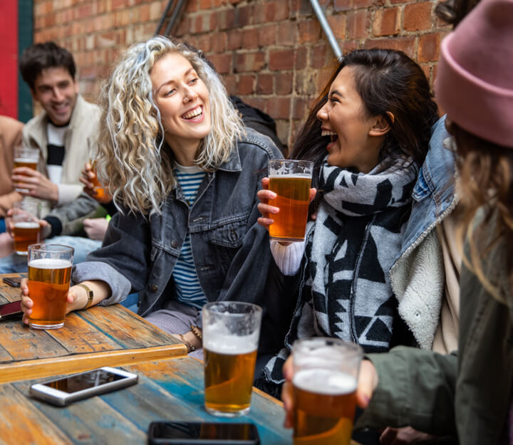 Graduates enjoying a drink together while playing Treasure Hunt Bath